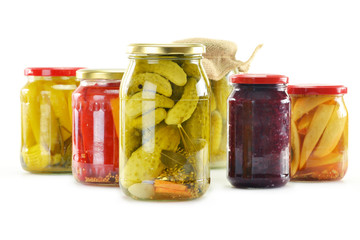 Composition with jars of pickled vegetables isolated on white