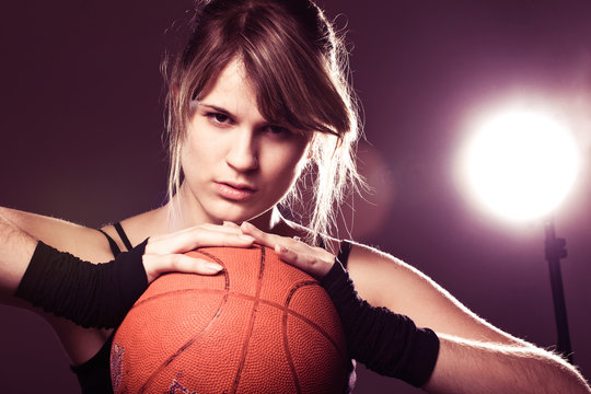 Female Basketball Player Holding Ball, In Black Background