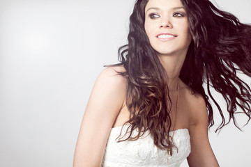 Naklejka premium Attractive female fashion model with long curly hair.