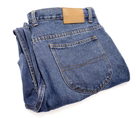 Pair of folded blue denim jeans isolated on white