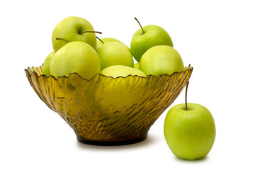 green apples in a glass vase on a white background