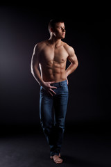 Fototapeta na wymiar man with naked torso in jeans posing in dark