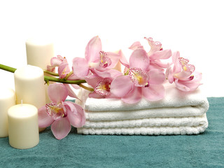 branch orchid on white towels with candle