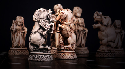 Fototapeta premium Chess pieces of horses stylized like mini sculptures