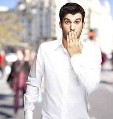 Fototapeta na wymiar Handsome young man surprised at a crowded city