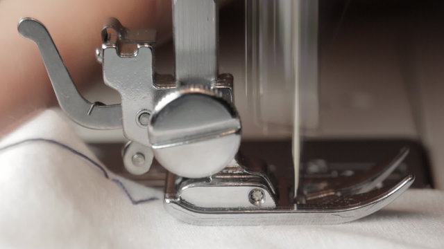 Close up on a sewing machine showing process.