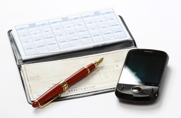 A pen and a mobile phone over a checkbook