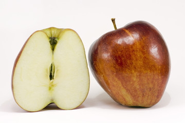 A ripe red apple and half apple