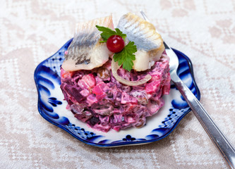 Food -  russian snack - vinaigrette  with herring fish