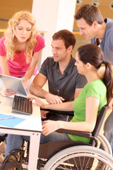 Woman in wheelchair attending group meeting