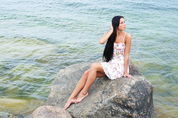 A young and beautiful woman near the sea