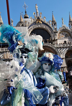 Masked couple with San Marco cathedral behind