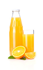 Orange juice glass bottle and oranges.