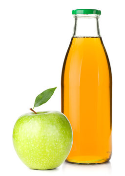 Apple juice in a glass bottle and ripe apple
