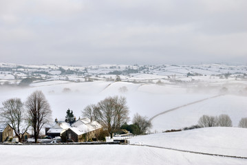 Small Farmhouse in Snow Covered Hills