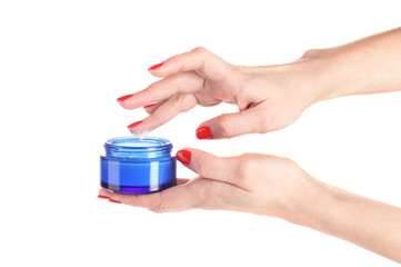 Female hands with manicure holding cream isolated on white