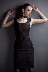 Fototapeta premium Redhead young girl in black dress