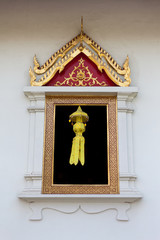 Lanna Thai style window of temple with Lanna lamp