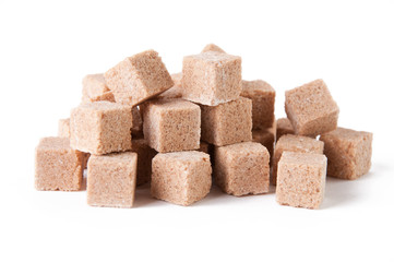 Cubes of brown sugar, white background