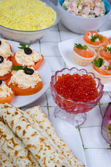 Pancakes with red caviar on a plate