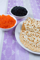 Pancakes with red and black caviar.