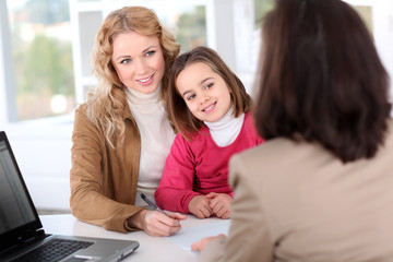 Woman in real-estate agency with kid © goodluz