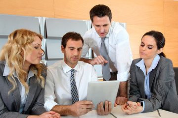 Business meeting in office with electronic tablet