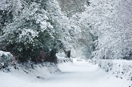 Path through English rurual countryside in Winter with snow