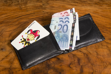 Euros with joker card in open wallet