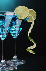 Blue cocktail in martini glasses on blue background