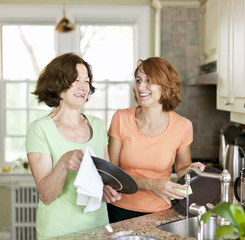 Women doing dishes in kitchen