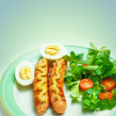 sausages on the grill with mustard, egg, salad and tomatoes