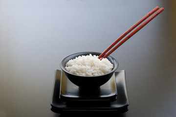 asian black rice bowl with plates and sticks