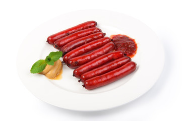 roasted sausages on porcelain plate
