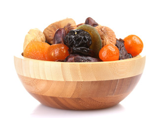 Dried fruits in wooden bowl isolated on white