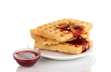 Tasty waffles with jam on plate isolated on white