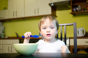 Little child eating breakfast