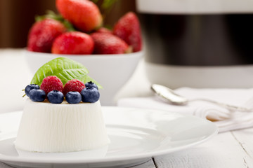 Panna cotta with Berries on white table