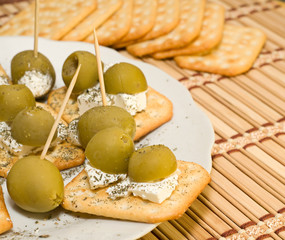 Crackers with olives and cheese feta