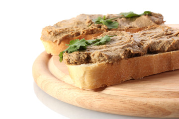 Fresh pate on bread on wooden board