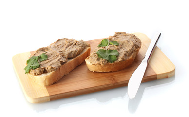 Fresh pate on bread on wooden board isolated on white
