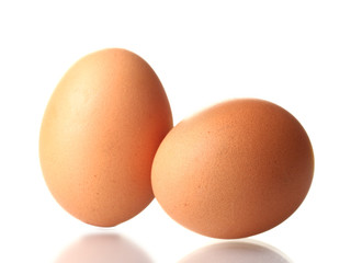 two brown eggs isolated on white