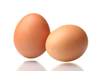 two brown eggs isolated on white