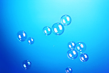 Soap bubbles on blue background