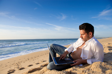 working in the laptop at the beach
