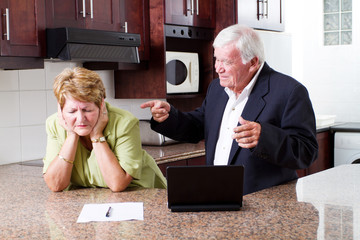 senior husband pointing fingers at his wife