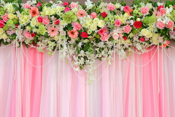 Beautiful exotic flowers arrangement over pink and white fabric