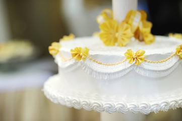 Delicious white and yellow wedding cake