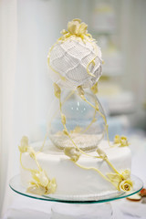 Delicious white and yellow wedding cake