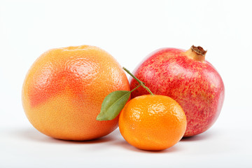 pomegranates and citrus fruits isolated on a white background.